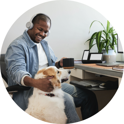 happy looking customer at home at desktop with dog