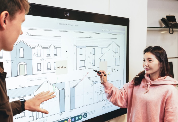 young-woman-and-man-using-a-webex-board-device