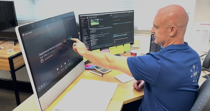 Person taps the green Join button on the screen of his Webex Desk to join a Webex Meeting from his office.