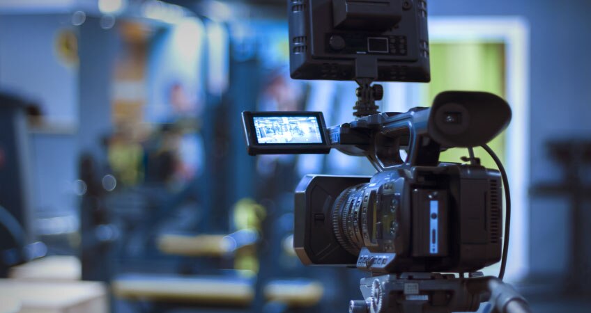 A large black professional video camera, ready for filming.