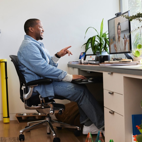 Person collaborates with a colleague via a video meeting.