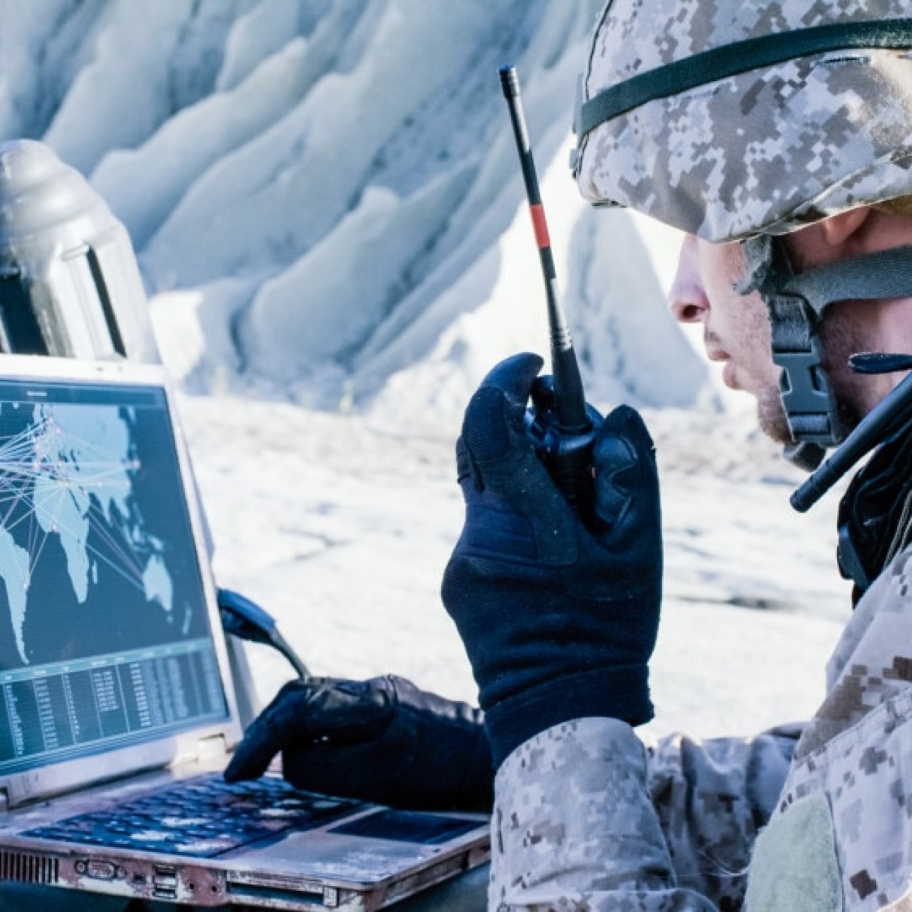 solider working on laptop in the field