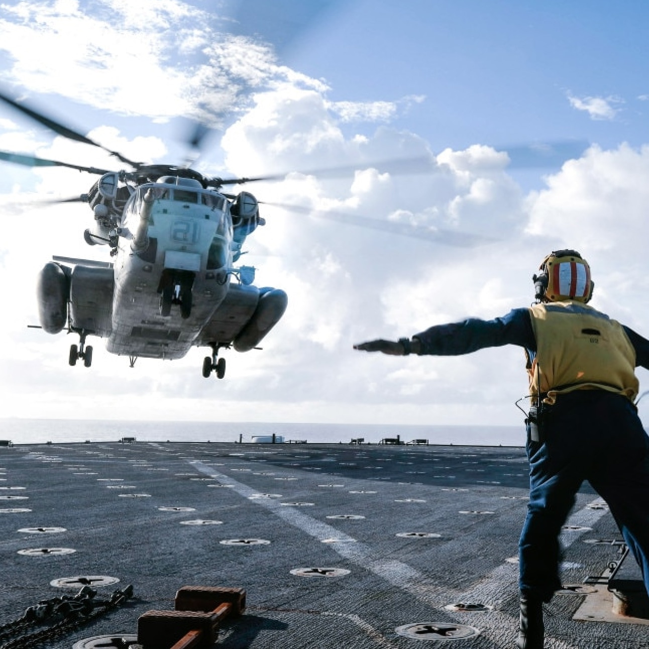 person helping helicopter land