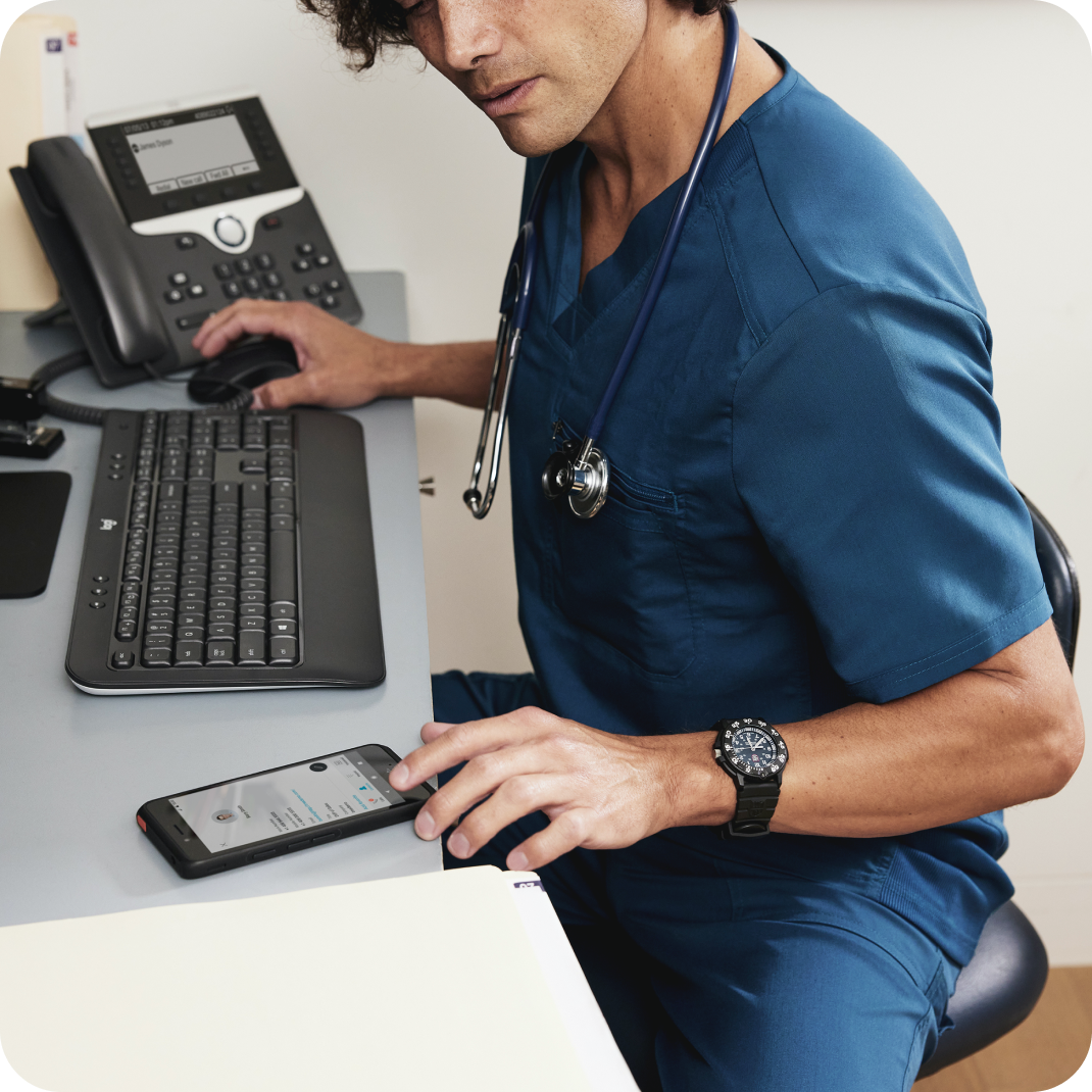 A person wearing scrubs and a stethoscope in a healthcare setting uses Webex video conferencing from a mobile device.
