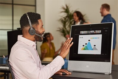 Person attending meeting on Cisco desktop device.
