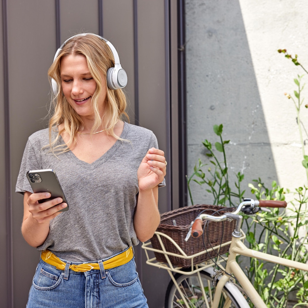 Person in a headset collaborates on-the-go via Webex Calling on a mobile phone. 