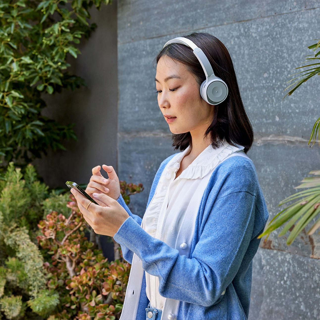 A professional interacting with a mobile device while on a call.