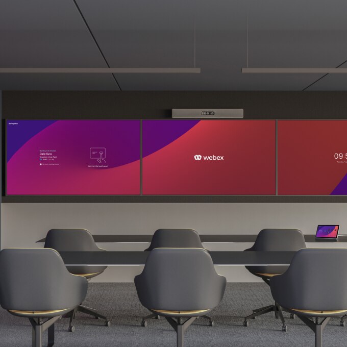 A large training room with the Cisco Room Kit Pro above three displays and a Cisco Board Pro against the side wall.