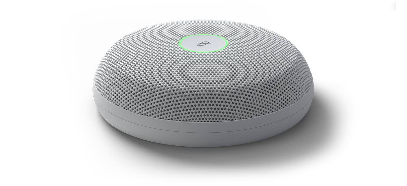 Front tilted close-up of the Cisco Table Microphone Pro device featuring a green status LED light around the top mute button, perforated steel mesh and a compact form factor.