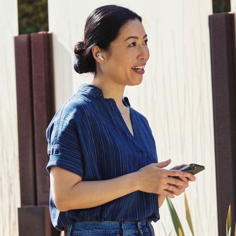 happy looking customer using mobile phone outside