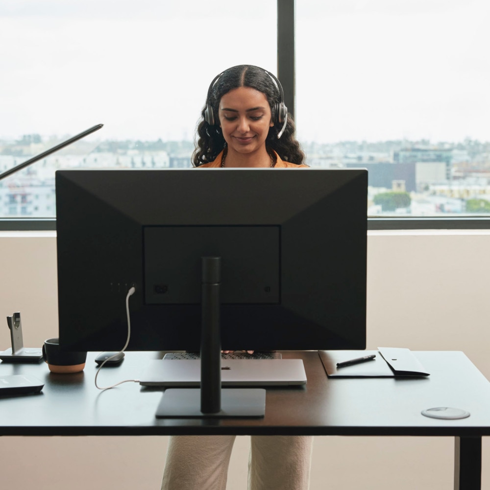 agent/rep working at standing desk