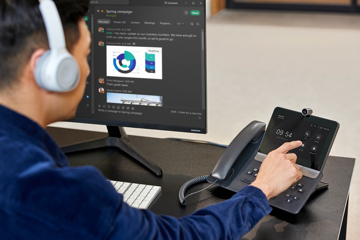 Employee uses desk phone and UCaaS platform while wearing Cisco headset.