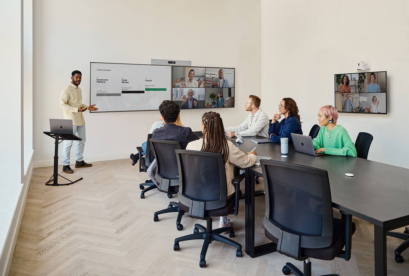 Man gives conference room presentation using UCaaS platform on Cisco Board device.