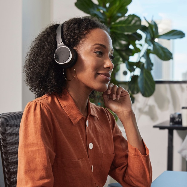 Remote worker listening to a video conference call using headphones outside