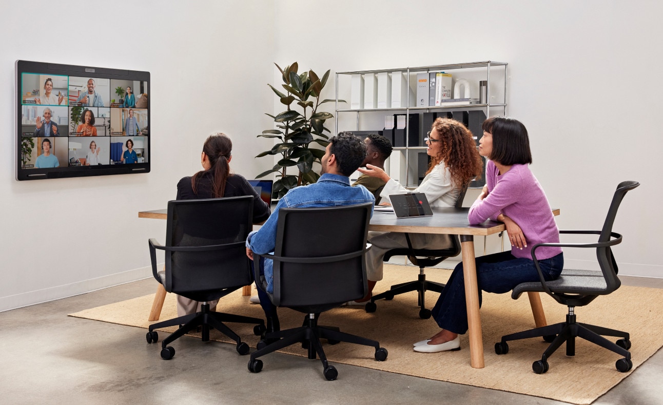 Group of coworkers in an office participating in a video conference call