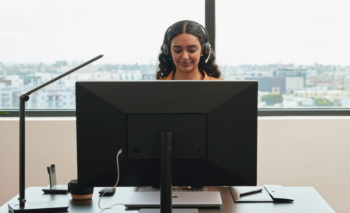 Call center attendant wearing a headset uses VoIP technology