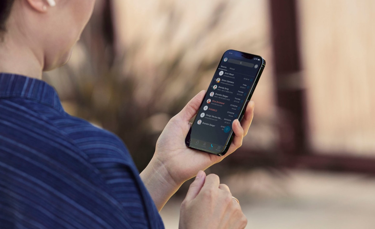 a person holds a VoIP-enabled smartphone