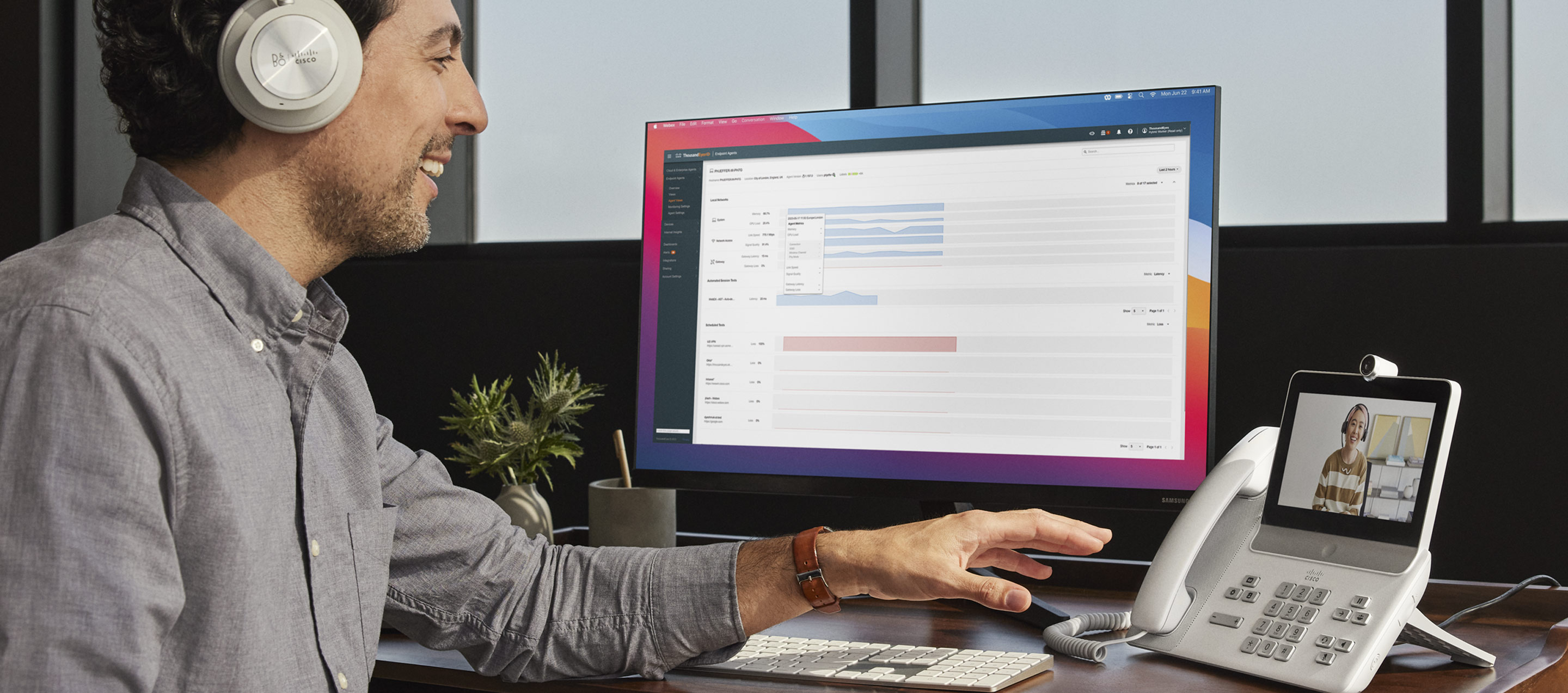 Employee uses Control Hub ThousandEyes integration on desktop monitor at workstation.