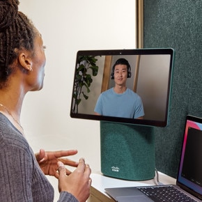Person collaborates with a colleague on a virtual meeting, using a Create an instant workspace with the portable video conferencing device designed for taking meetings with you to any room..