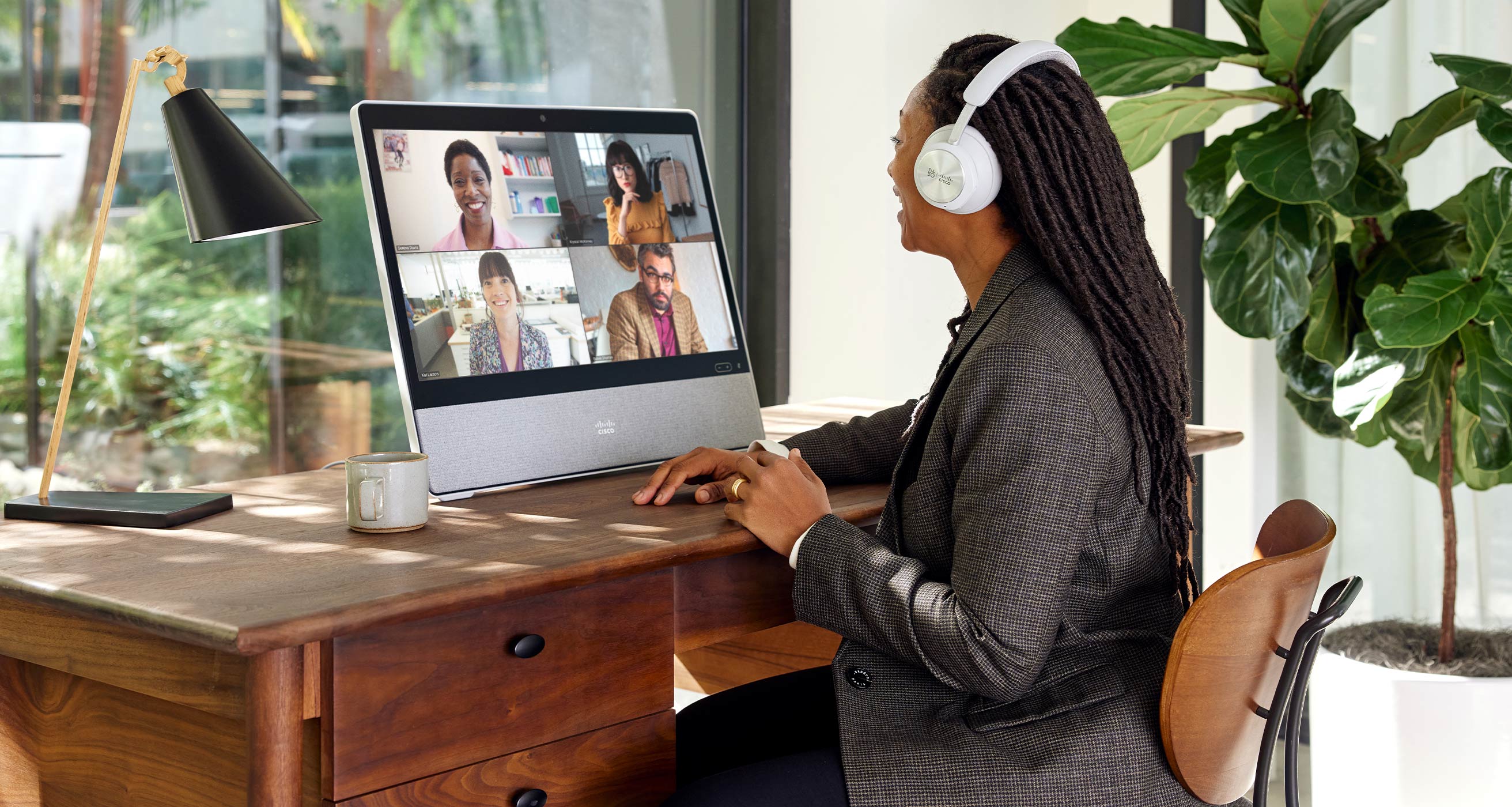 Remote worker uses Cisco Desk Pro for video conference on Microsoft Teams.