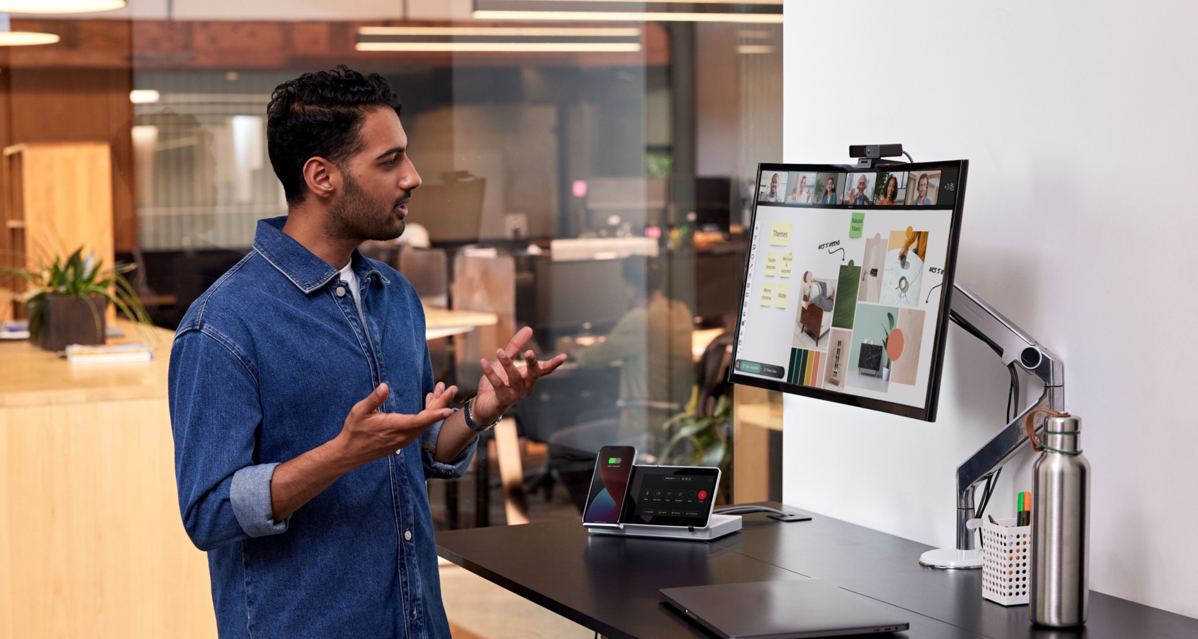 A professional video conferences with colleagues via Webex, collaborating through a Miro board embedded in Webex Meetings.