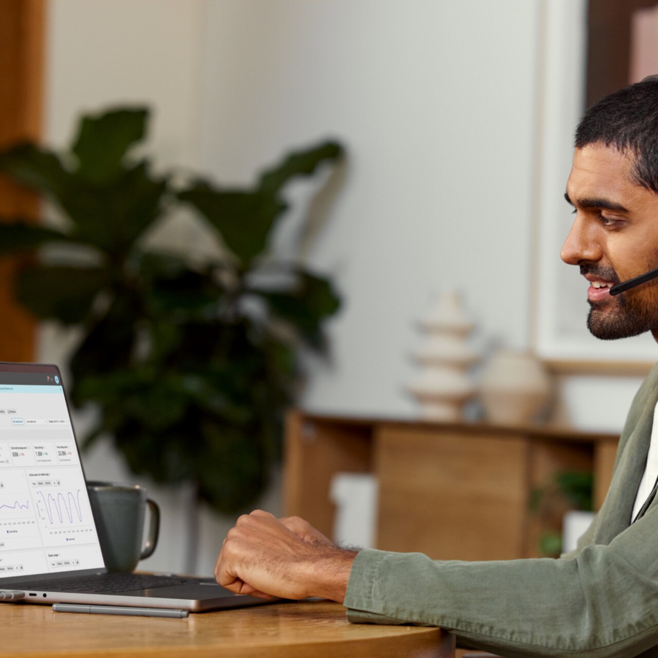 Professional looks at the Webex Control Hub interface on a laptop screen. It shows various company-wide Webex usage stats.
