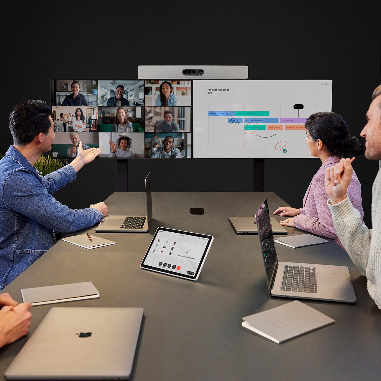 Employees video conferencing using Cisco Board Pro, Cisco Room Bar, and Cisco Room Navigator.
