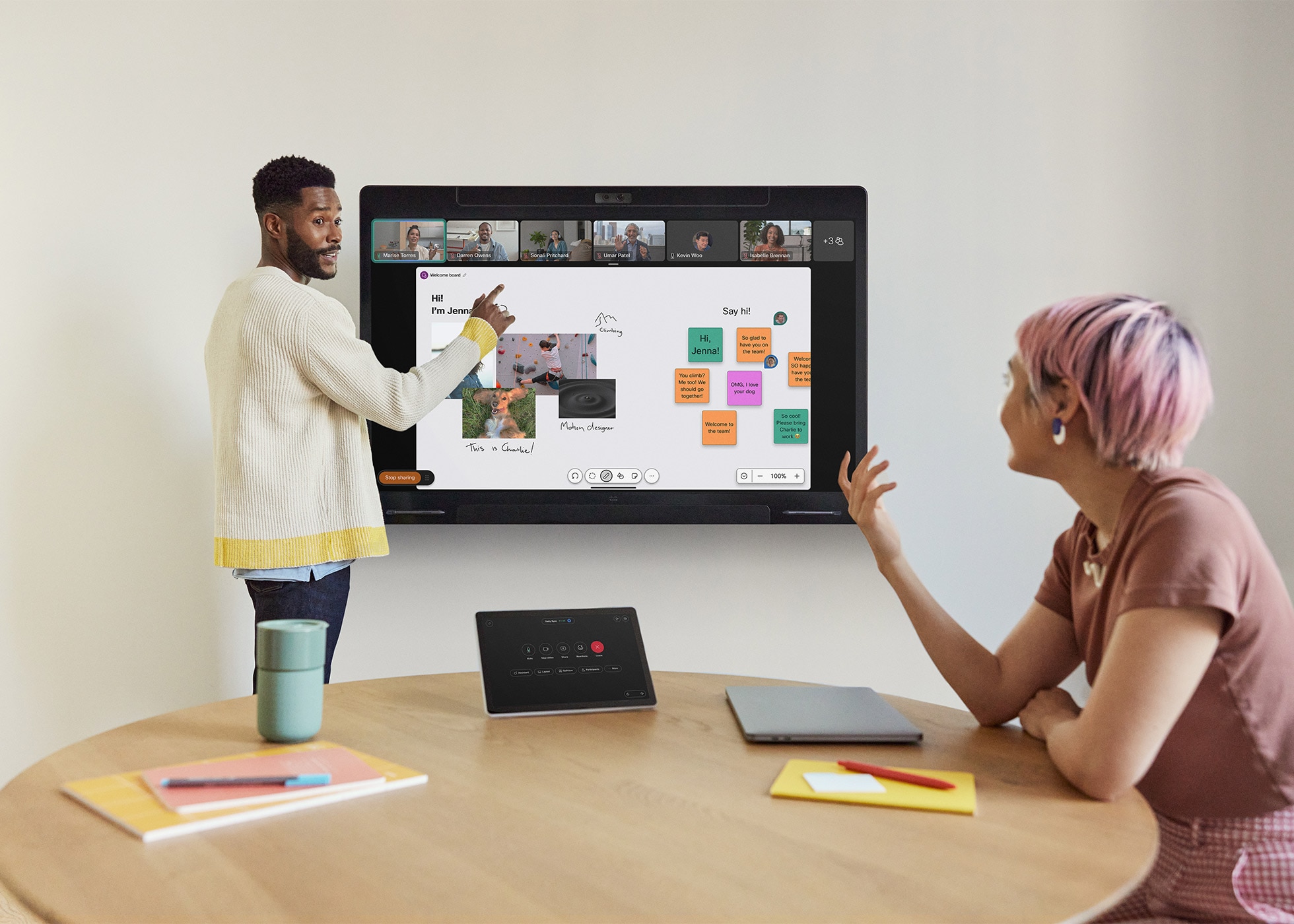 Employees use Cisco Board Pro, Cisco Room Navigator, and RoomOS to collaborate in small conference room.