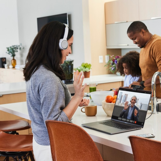 Person seamlessly collaborates from their kitchen, elevating a Webex call into a full-featured video meeting.