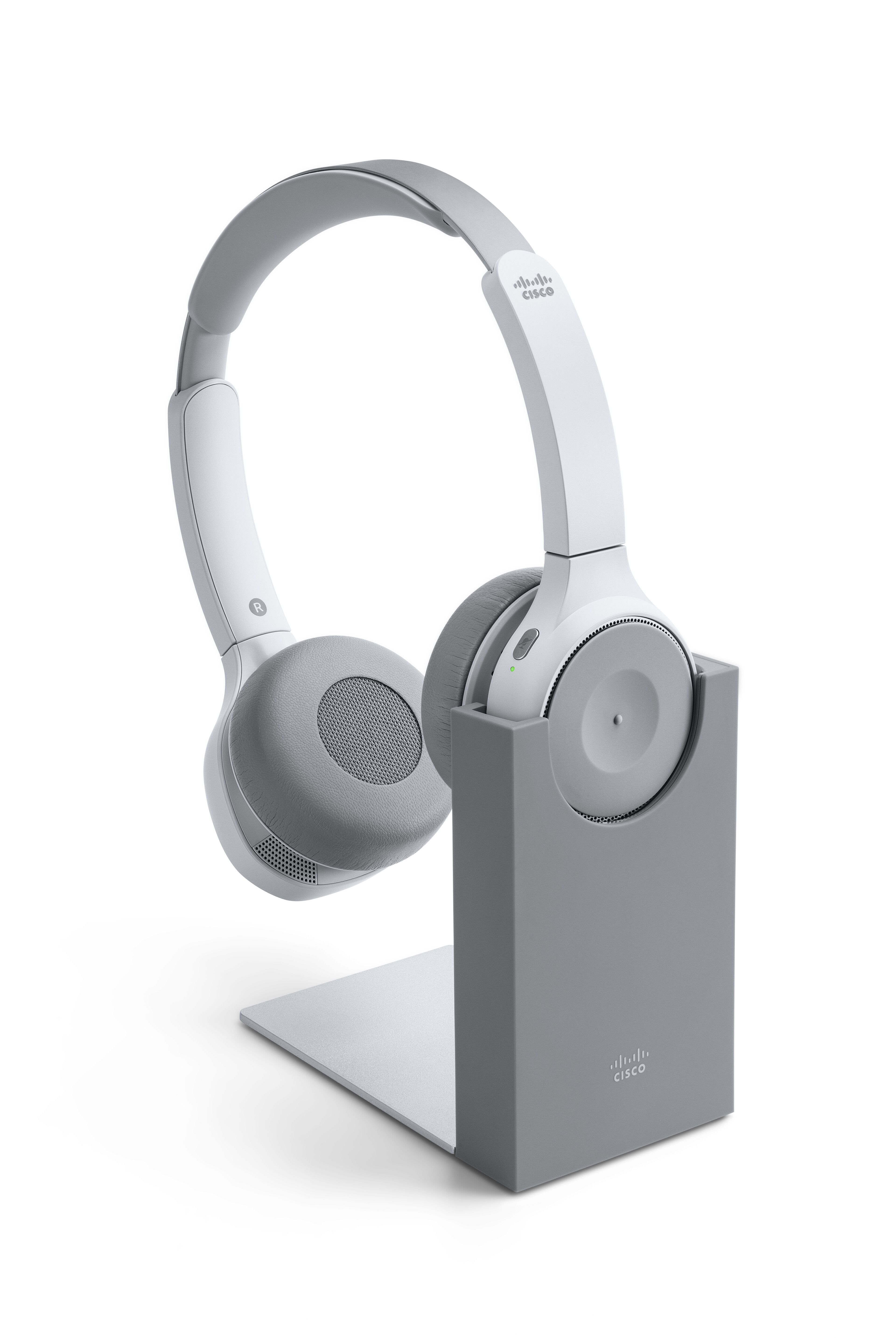 The Cisco Headset 730 in platinum, shown in its charging stand